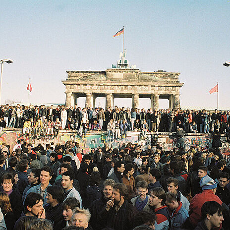 Menschen aus West- und Ostberlin auf der Mauerkrone am Brandenburger Tor, 10.11.1989 Menschen drängen sich vor der Mauer am Brandenburger Tor in Berlin am 10.11.1989